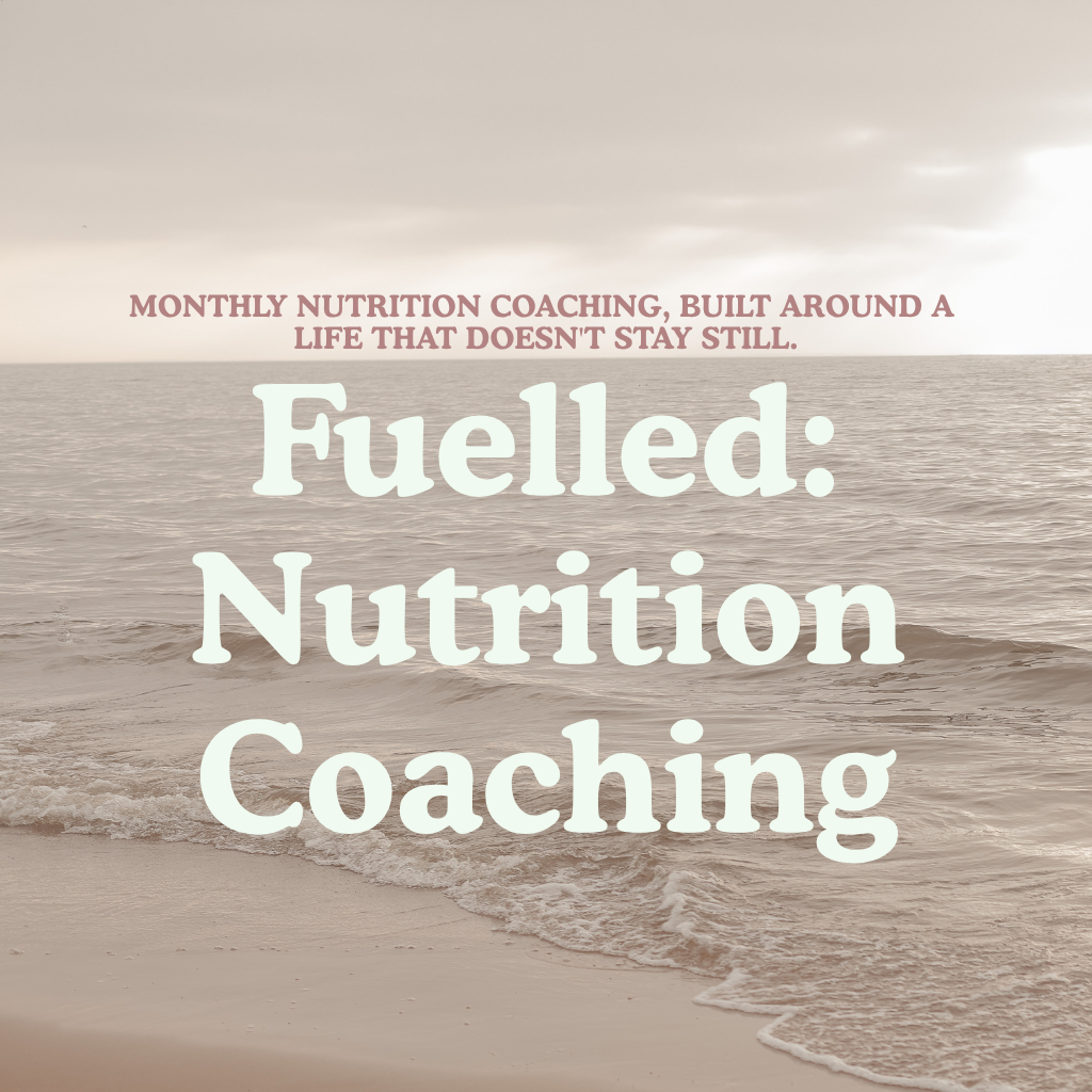 Beach scene with pale sand, ocean water, and overlaid text reading 'Monthly Nutrition Coaching, Built Around A Life That Doesn't Stay Still. Fuelled: Nutrition Coaching'.