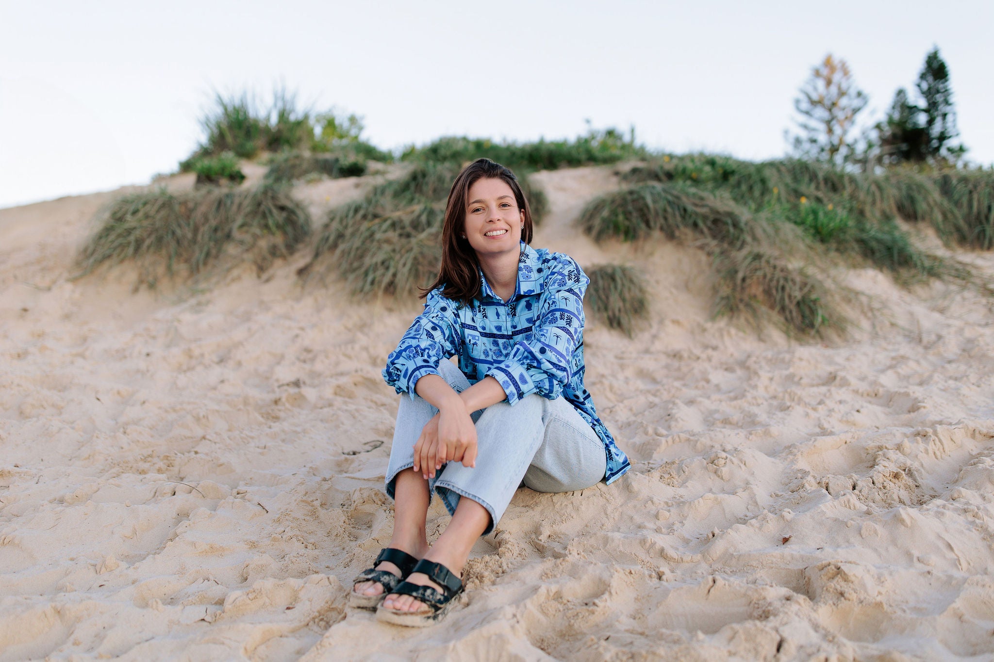 Nuala sitting on a beach thinking about bespoke meal plans