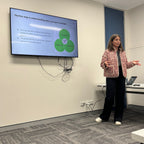 Nuala giving a gut presentation in front of a screen with a diagram